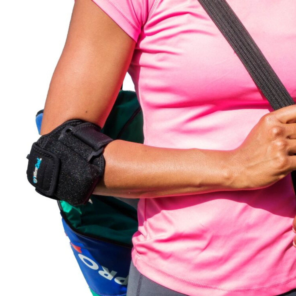 A close-up of a person wearing a VibraCool Easy Fit for elbow support brace on their right arm, paired with a pink athletic shirt and a blue bag.