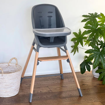 MOOSE Harper High Chair in charcoal grey with natural wooden legs, feeding tray and adjustable footrest.