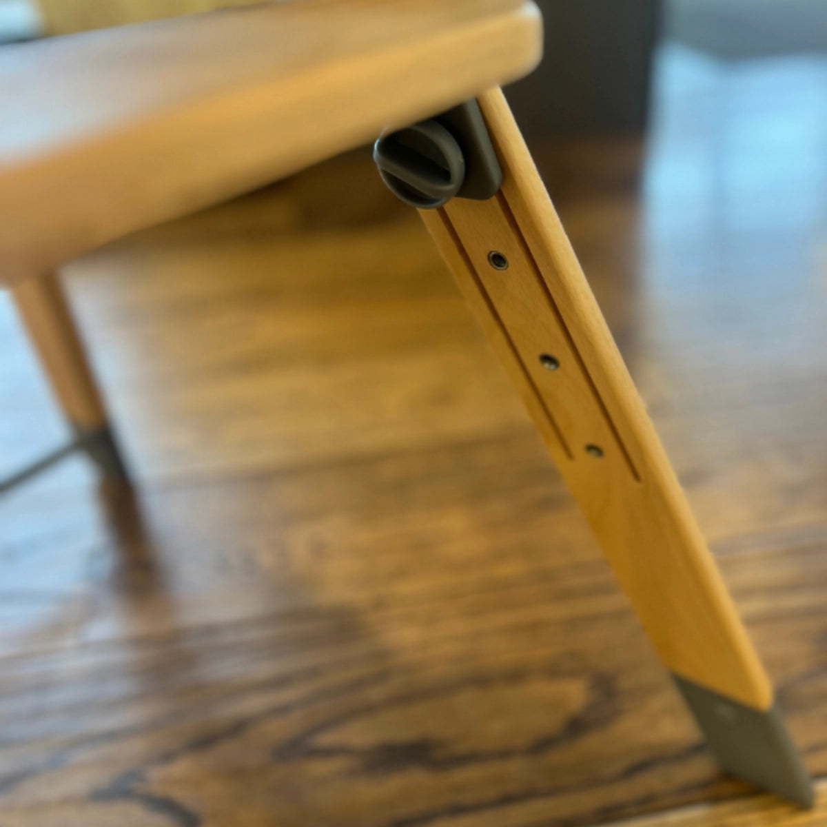 Close-up of the MOOSE Harper High Chair wooden footrest and height adjustment positions.