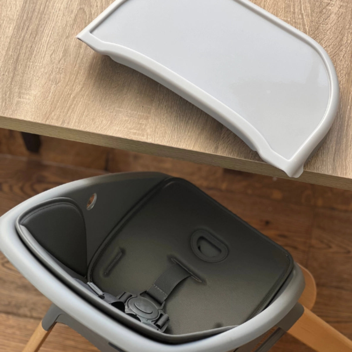 MOOSE Harper High Chair with the feeding tray removed to show the padded seat and harness.
